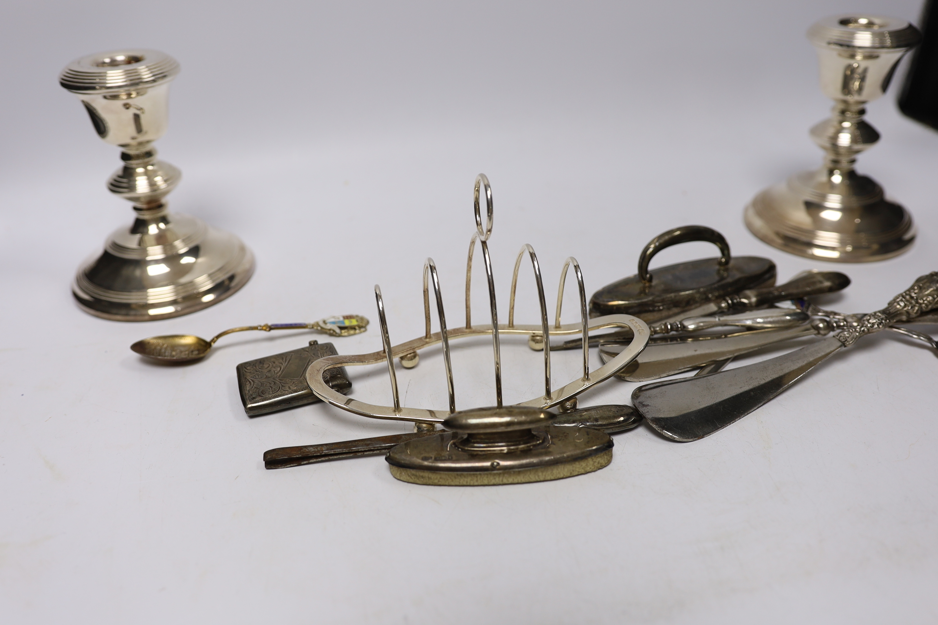 A George V silver christening mug by Charles Edwards, London, 1912, 86mm, together with two silver mounted cigarette boxes, two silver cigarette cases, a pair of silver mounted dwarf candlesticks, a silver vesta case, a